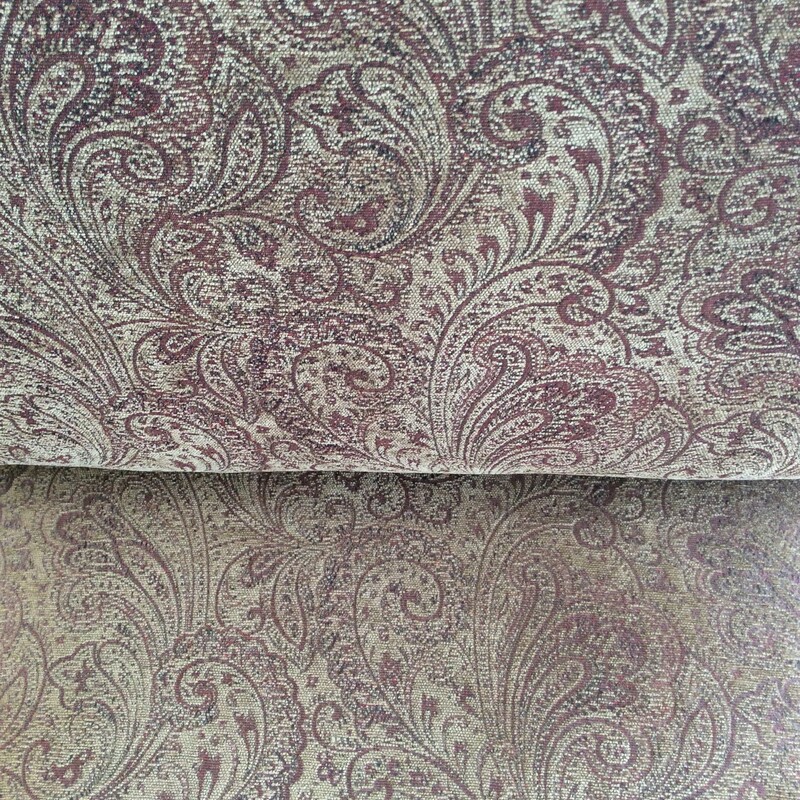 This upholstered club chair features a paisley pattern in red and gold. Good condition.