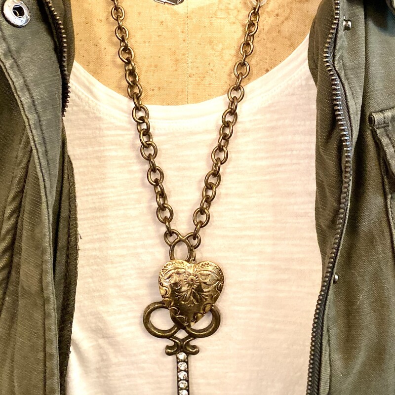 This is a one of a kind necklace made with a heavy bronze chain; genuine suede and an extra large key & heart. This is the perfect go to necklace to add a little pop to any outfit. Look how cute it is with just a white t-shirt and army green jacket.