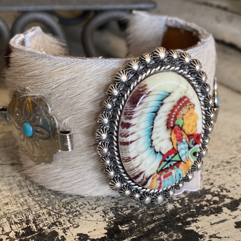 This is a one of a kind handmade cowhide cuff bracelet with Native American and Western touches.