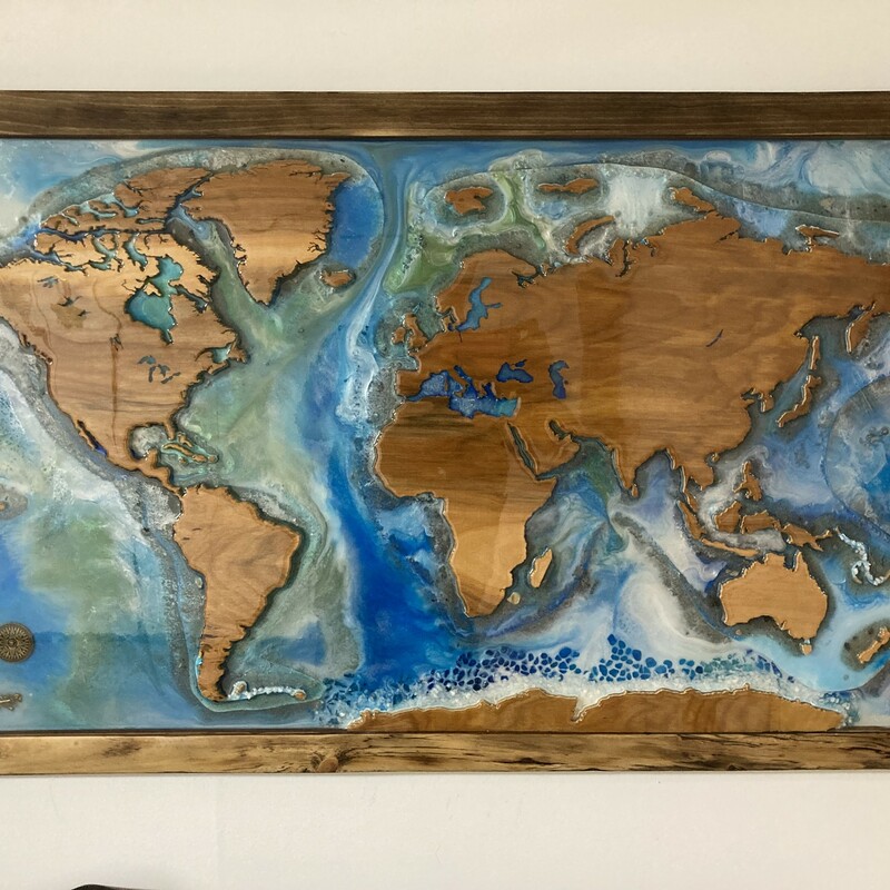 World Map<br />
Size: 40x24 inches<br />
<br />
This world map is a great conversation piece and at 24x40 is the perfect size for over a fireplace or in an entry way. This unique piece will make an unforgettable impression on anyone who sees it.<br />
<br />
This piece was created with hand-cut reclaimed wood and epoxy resin - no laser cutter or CNC used. Each piece is unique. The frame has marks from the wood's previous life. The map is reclaimed birch. The epoxy<br />
resin used is non-toxic, food-safe and no-VOC.<br />
<br />
When choosing products for your home that contain resin please know what you're buying. The epoxy resin we use is much more expensive because it is non-toxic. It is formulated using the highest quality materials and therefore produces no VOCs or fumes. It is a clean<br />
system, meaning there are no solvents or non-reactive<br />
diluents - everything in it reacts so nothing is free to become airborne and cause health issues. Our resin is so safe it can be safely used as a food contact surface.