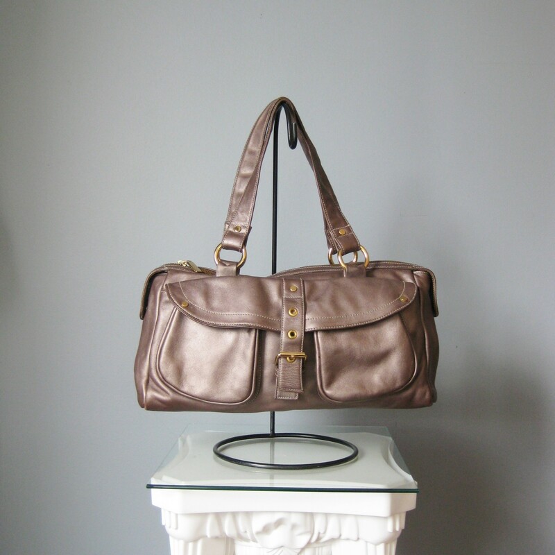 Perlina Shldr, Bronze, Size: None<br />
Very popular and useful style handbag from<br />
Perlina in a rosy bronzy metallic finish leather<br />
Two outside pockets secured with a strap that has a buckle but also just snaps down for easy access.<br />
Big simple interior with two slip pockets<br />
Made in Korea<br />
Double handles<br />
Godl Hardware<br />
excellent pre owned condition, no flaws<br />
16in x 6.5in x 4.5in<br />
handle drop: 9in<br />
<br />
<br />
thanks for looking!<br />
#40588