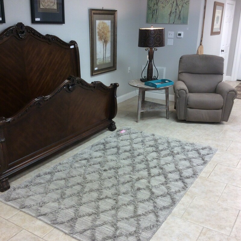 Very cool area rug by The Rug Republic of Uttermost. It measures a 5' x 8', is handwoven and features a diamond pattern in soft gray.