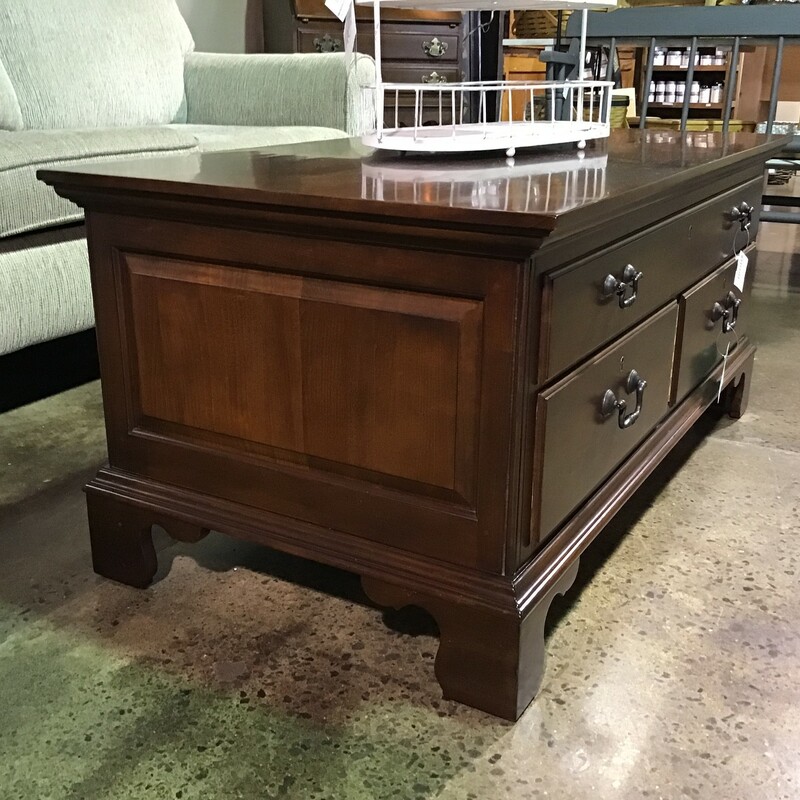 This beautiful dark brown wood coffee table has three drawers; 1 large and 2 smaller. A staple in any family room, this neutral brown wood would look lovely. The simple design would make this a great addition to a family room or living room.

Dimensions: 44 in x 24 in x 20 in