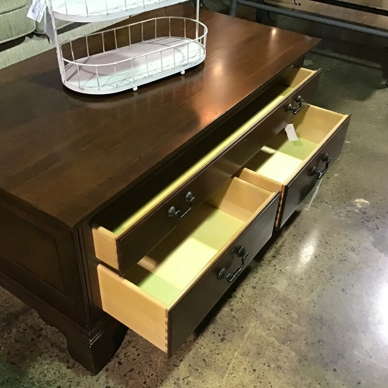 This beautiful dark brown wood coffee table has three drawers; 1 large and 2 smaller. A staple in any family room, this neutral brown wood would look lovely. The simple design would make this a great addition to a family room or living room.

Dimensions: 44 in x 24 in x 20 in