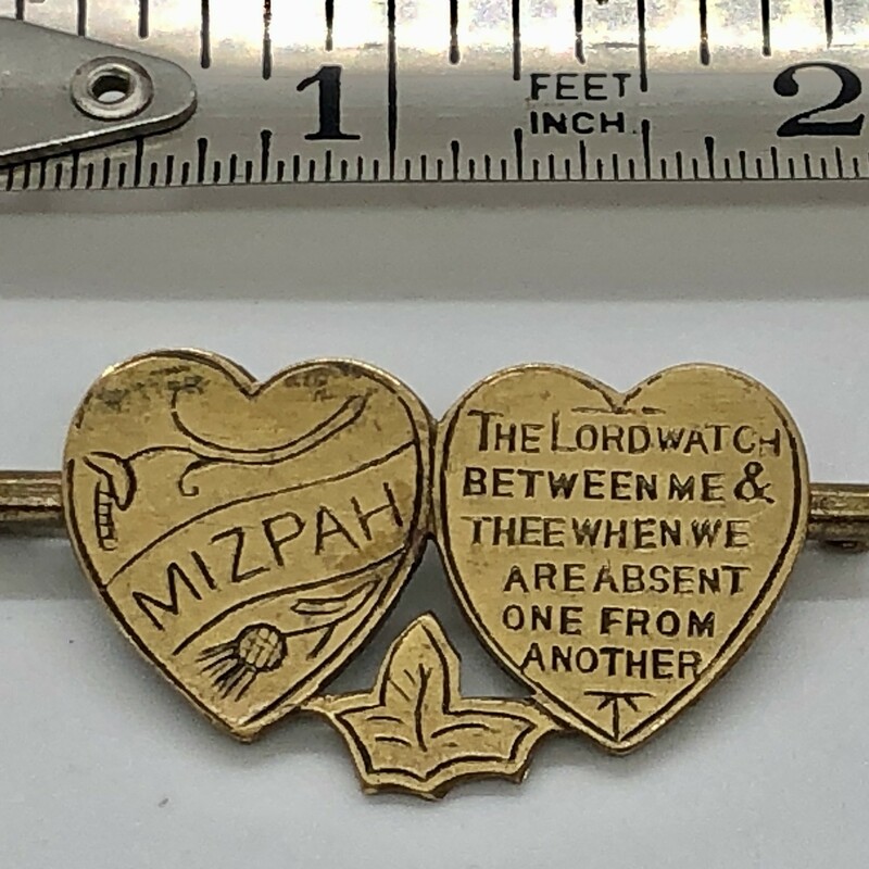 Mizpah Brooch in Brass c.1890-1915.<br />
The Lord watch between me and thee when we are absent from each other.<br />
Mizpahbrooches are given as symbols of protection and togetherness.  The word itself means 'watchtower' in Hebrew and this traditiion was particually popular in English Victorian jewelry.