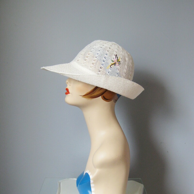 Sporty yet ladylike this summery straw hat is made of an open weave fabric.  It's not stiff but does hold its shape.  Darling floral embroidery on one and a jaunty turn up brim that extends in front to sheild the eyes from the sun.  Inner hat band measures 23in, this is large, my mannequin is pretty small so this hat will probably sit a bit higher on your head than on hers.
no labels
Perfect condition.
Thanks for looking!!!
#380