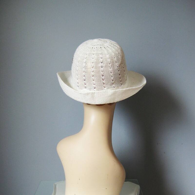 Sporty yet ladylike this summery straw hat is made of an open weave fabric.  It's not stiff but does hold its shape.  Darling floral embroidery on one and a jaunty turn up brim that extends in front to sheild the eyes from the sun.  Inner hat band measures 23in, this is large, my mannequin is pretty small so this hat will probably sit a bit higher on your head than on hers.<br />
no labels<br />
Perfect condition.<br />
Thanks for looking!!!<br />
#380