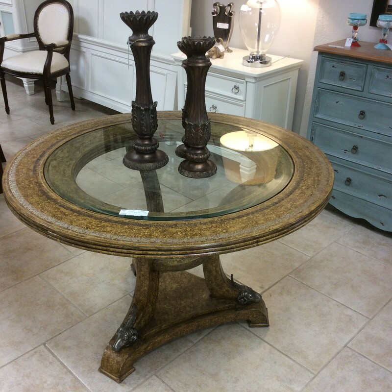 Beautiful round glass entry table encircled in an embossed trim. It is a brown and gold color with a faux finish. It has three metal ram heads on the base which make it very unique......
Measures 45x29