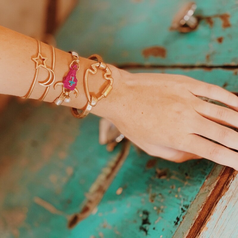 Pink Cow Skull Bangle. Pink skull with turquoise cross. Pearl accent. Silver and gold tones.
