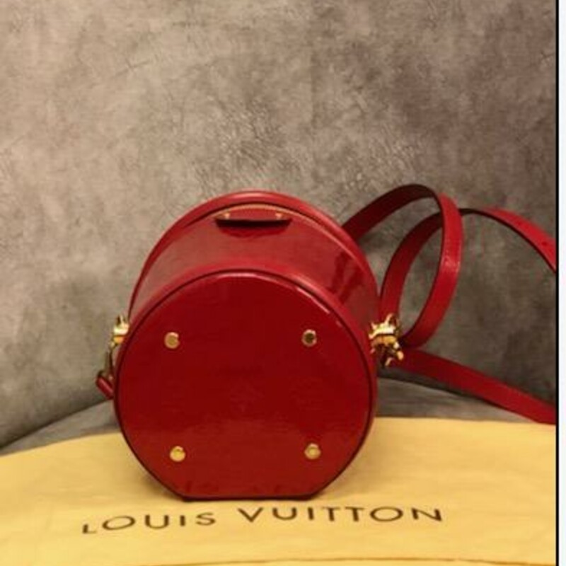 Authentic Louis Vuitton
Cannes Red Leather Handbag
2019 Louis Vuitton Cannes \"Rouge\" handbag was inspired by that indispensable piece of feminine luggage: its lush, cylindrical silhouette is crafted from lustrous Monogram Vernis embossed patent leather. With all the added details calf-leather trim, Toron top handle, removable, adjustable leather strap (drop: min. 50 cm/19.7 inches, max. 55 cm/21.7 inches) for shoulder or cross-body carry. Ideal for formal occasions, the Cannes handbag can be worn across the body or carried in the palm. Its cylindrical shape, roomy enough to hold all the necessary items, is made from embossed Monogram Vernis patent leather with a luxuriously glossy finish. The bag draws inspiration from traditional beauty cases and was designed for the Pre-Fall Collection.
- Microfibre lining,
- gold-tone hardware
- zip closure
- four protective bottom studs
Material: Calf leather / Calf leather trim
Dimensions: Height 17cm / 6.7\", Width 15cm / 5.9\", Depth 15cm / 5.9\".
Made in France
FL2129
COMES WITH ORIGINAL DUST COVER!
COMES with CERTIFICATE OF AUTHENTICITY
This bag is in like new condition.  You can find this bag for resale on TRADESY right now for 3453.00 AND at Vintage by Misty has this bag for 3250.00
This is an Amazing Price for such a Stunning Handbag!