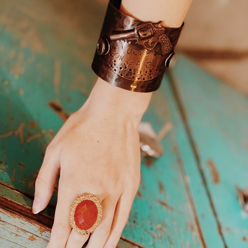 This brass cuff bracelet is definitley a statement piece measuring  2.5 inches tall! If you love unique and eclectic fashion this is the bracelet for you! It reads Lucky Son of a Gun