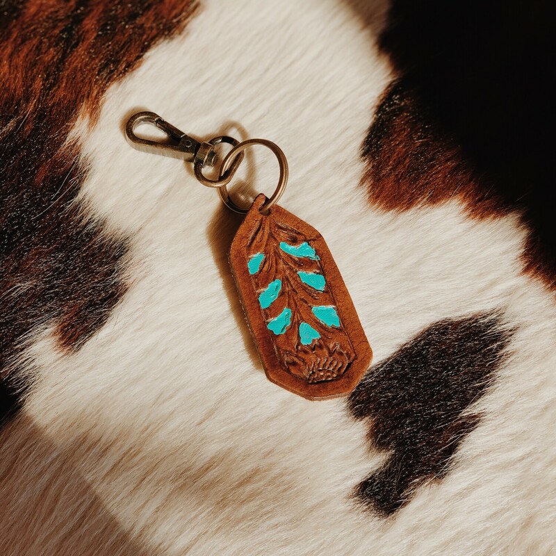 These adorable Myra brand keychains measure 6 inches in length. They are beautifully carved and painted in turquoise!