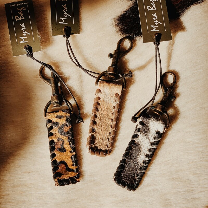 These adorable Myra brand keychains measure 5 inches in length. No two cowhides are alike, so the product differs slightly from keychain to keychain. You can select the general color scheme you would like below!
