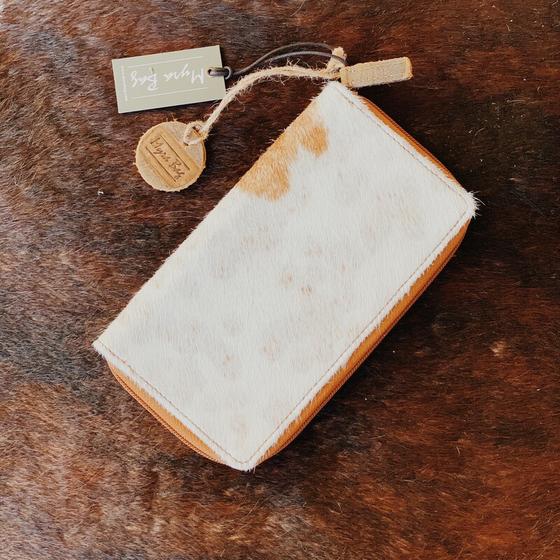 This Myra brand cowhide wallet measures 4.5 inches by 8 inches and zips shut. Inside, it has two cash compartments, a buttoned coin pouch, and seven card slots!