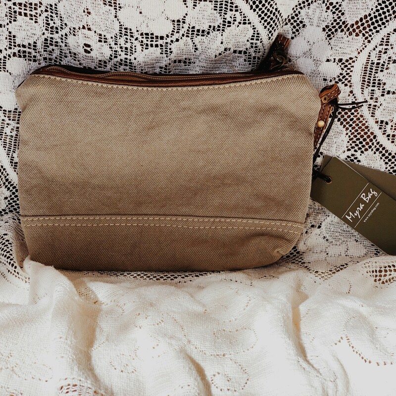 This Myra brand wristlet measures 9.5 by 7.5 inches and zippers shut. It is a pouch with one singular compartment.