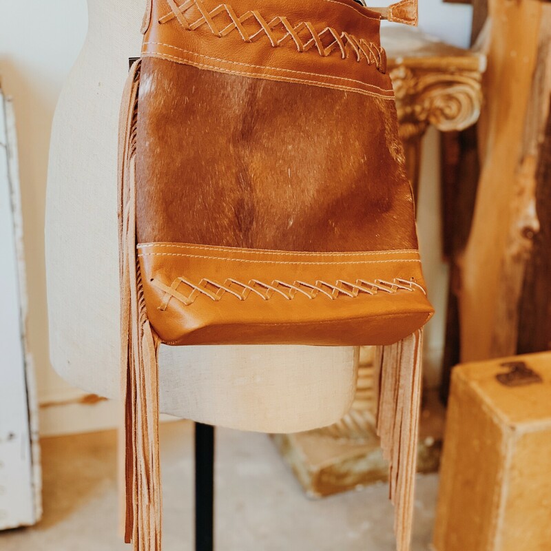 Myra purses are made from quality leather and cowhide! This purse is fabric lined and three inside pockets, as well as one outside pocket!<br />
Measurements: 12 inches tall, 13 inches wide, 3 inches deep