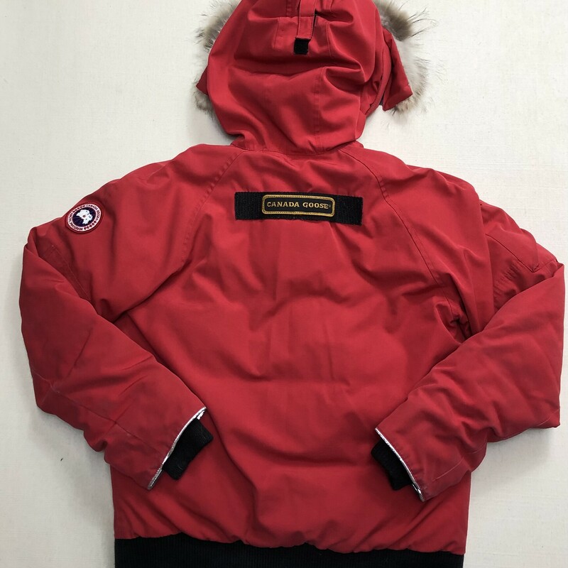 Canada Goose Rundle Down Bomber with a Fur Hood, Red,<br />
Size: 14-16Y<br />
<br />
Some Wear On Cuff and Eleastic waist band<br />
<br />
Bomber jacket made in water and wind-resistant with a removable fur ruff and reflective piping at cuffs. Features tricot-lined storm flap, reinforced elbow patches, adjustable tunnel hood and additional fabric at sleeve for 1.5 extension for child growth.<br />
Arctic Tech (85% Polyester, 15% Cotton); Fill: 625 Fill Power White Duck Down; Trim: Coyote Fur<br />
Zipper, snap button closure<br />
Made in Canada