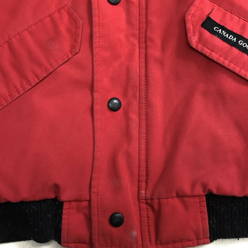 Canada Goose Rundle Down Bomber with a Fur Hood, Red,<br />
Size: 14-16Y<br />
<br />
Some Wear On Cuff and Eleastic waist band<br />
<br />
Bomber jacket made in water and wind-resistant with a removable fur ruff and reflective piping at cuffs. Features tricot-lined storm flap, reinforced elbow patches, adjustable tunnel hood and additional fabric at sleeve for 1.5 extension for child growth.<br />
Arctic Tech (85% Polyester, 15% Cotton); Fill: 625 Fill Power White Duck Down; Trim: Coyote Fur<br />
Zipper, snap button closure<br />
Made in Canada