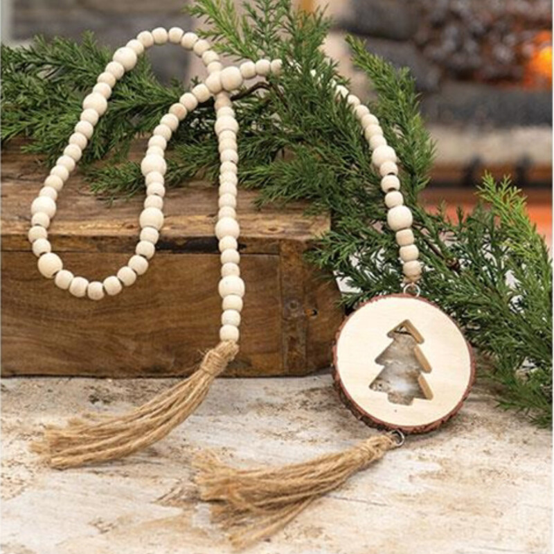 This natural wood tree bead strand looks great wraped around a farmhouse tree or displayed on a holiday mantle.  These beads feature round wood beads, a wood slice on one end with a festive tree cutout and jute tassels. The tree slice is 3 inches in diameter and measure 47 inces in length
