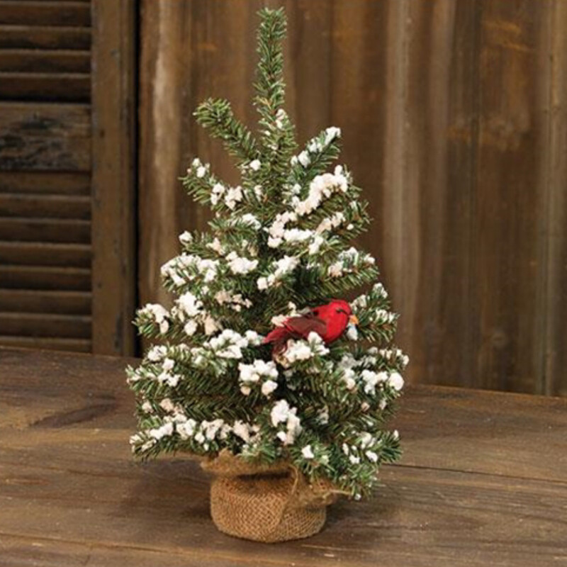 Snowy German twig tree with cardinal features branches of frosted greenery that sparkle with silver glitter on a burlap-wraped base. A foam cardinal with a velvet body and fabric feathers sits on one of the branches.  Tree measures 16 inches high