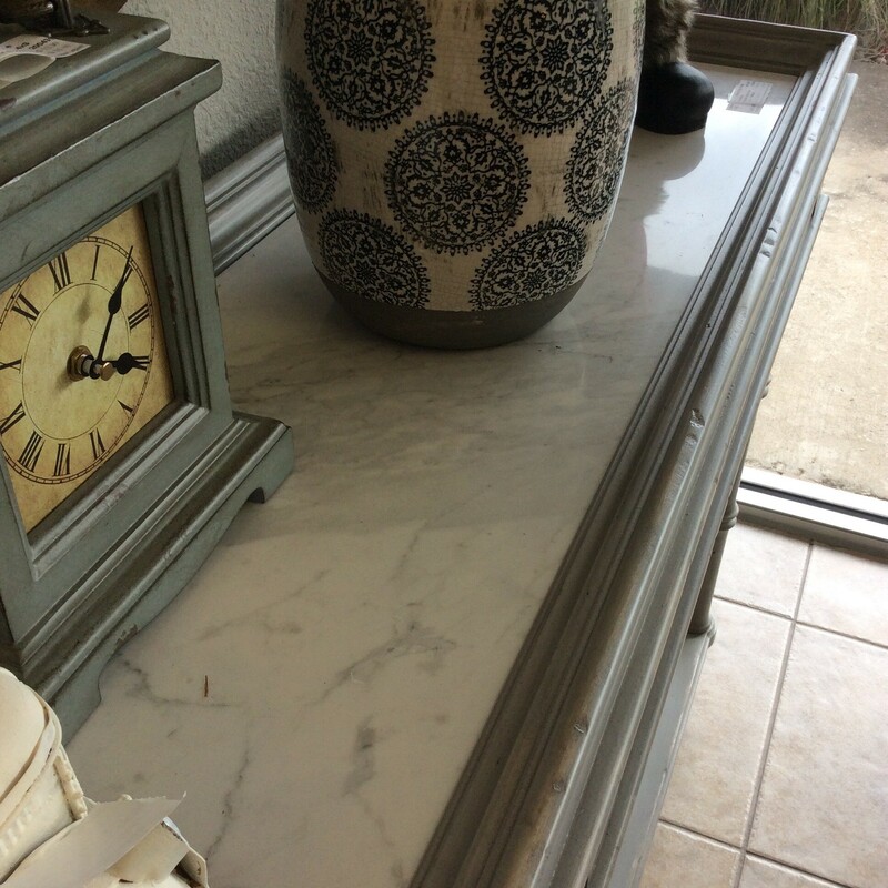 Gorgeous! Delicate and intricate yet stately and sophisticated. This sofa table will make a striking accent to define your space. Painted the softest of grays with distressing for that timeless, aged look that is so popular. There is a tiny drawer on each end and the tabletop is white marble.