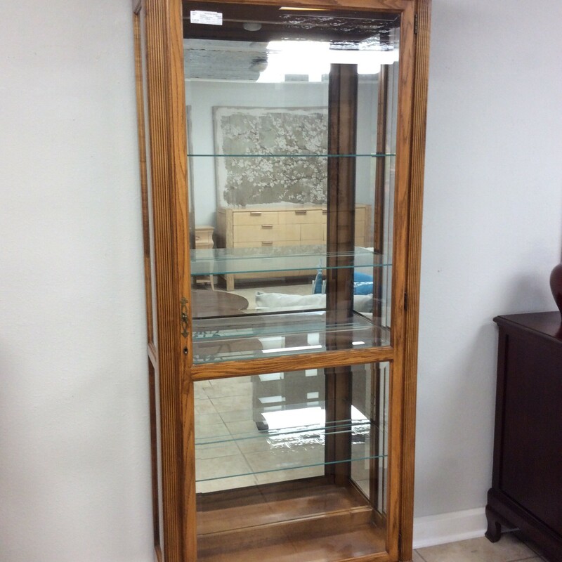 Plenty of room for all your collectibles!
This is an all glass Howard Miller curio. It is light wood with dental molding trim. It is also lighted and has four glass shelves.

Measures 35x80x30