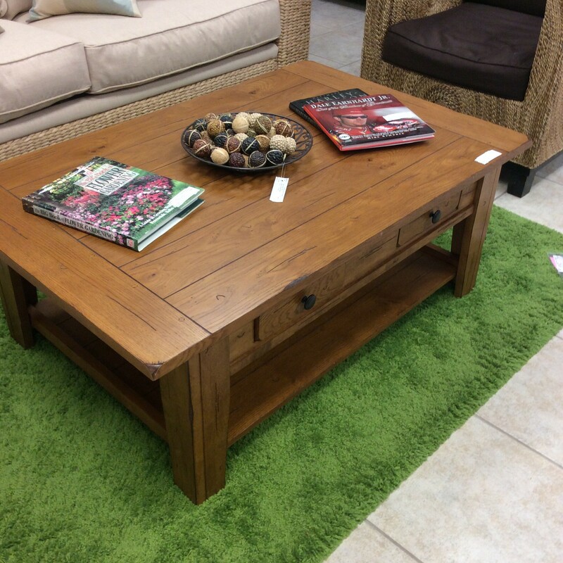 Very nice plank top coffee table. It is a distressed pine. It has a large shelf on the bottom and two drawers. This coffee table would go well with alot of different decor.
Measures 50x32x19