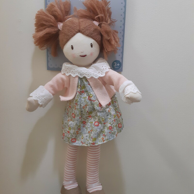 Made from carefully chosen fabrics, this doll is high quality and hand finished with love. She wears a knitted cardigan and a floral dress, all of which are removable. She even wears little pants!