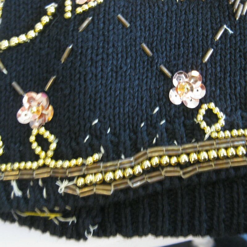 Gorgeous vintage sweater in Black with very sparkly gold sequin floral embroidery
55% Ramie and 45% cotton
Marked size Medium but will fit a size large as well
Flat Measurements
Armpit to Armpit: 22
Underarm sleeve seam length: 19.25
Length from back neck to hem: 28

Excellent condition with a few beads missing near the hem as shown
thanks for looking!

#43984
