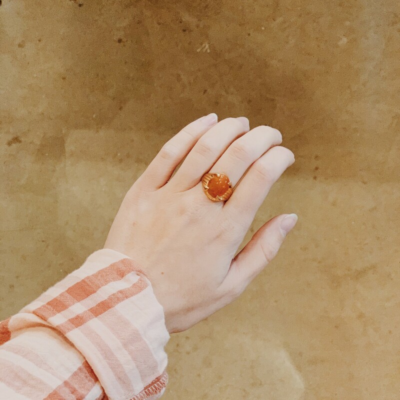 Beautiful gold colored ring with an orange stone!