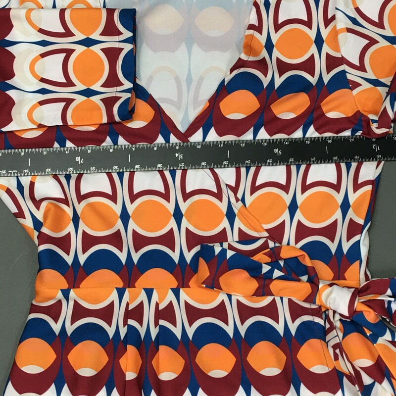 Laura Estrada, Pattern, Size:S/ M. Laura Estrada, Pattern, Size: M 3/4 sleeve,55% polyester / 45% rayon geometric print  tangerine, brick red, yale blue, and white. This is a light pull over, cute V neck wrap and tie at the side of the waist, unlined dress. This dress falls just over the knees, and is a probable fit for size 6 to 8. Please see the measurements. There are no material tags. Columbian designer Laura Estrada is exclusive to L'Unique Boutique in CT. This dress is one of a kind!<br />
8.4 oz