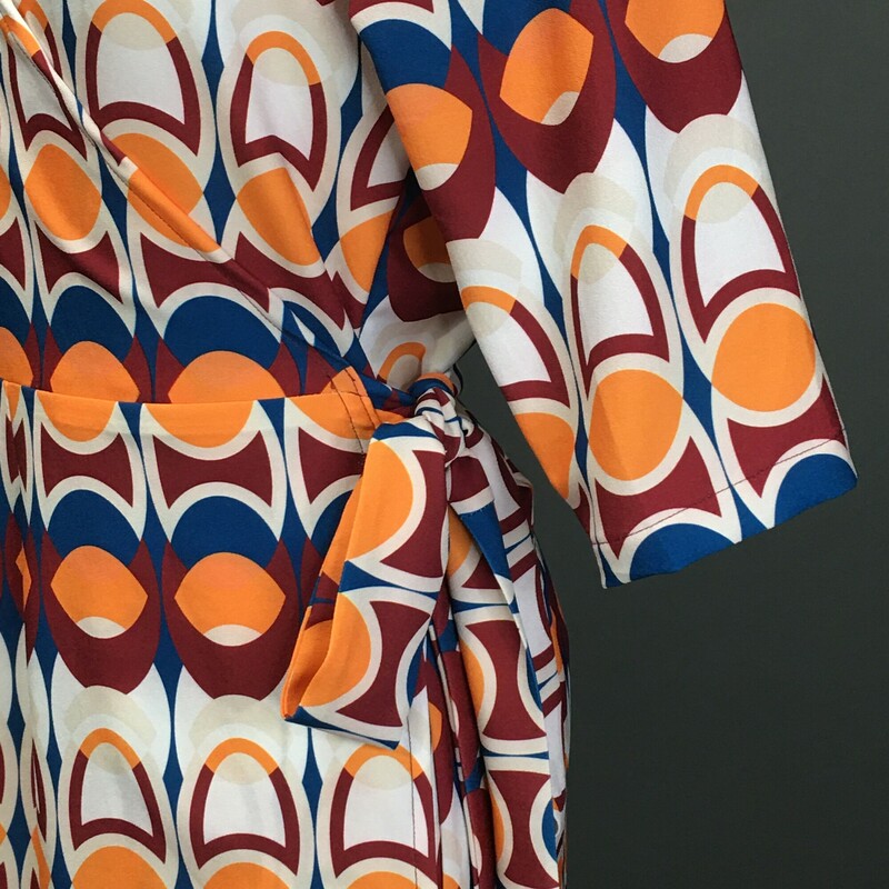 Laura Estrada, Pattern, Size:S/ M. Laura Estrada, Pattern, Size: M 3/4 sleeve,55% polyester / 45% rayon geometric print  tangerine, brick red, yale blue, and white. This is a light pull over, cute V neck wrap and tie at the side of the waist, unlined dress. This dress falls just over the knees, and is a probable fit for size 6 to 8. Please see the measurements. There are no material tags. Columbian designer Laura Estrada is exclusive to L'Unique Boutique in CT. This dress is one of a kind!<br />
8.4 oz