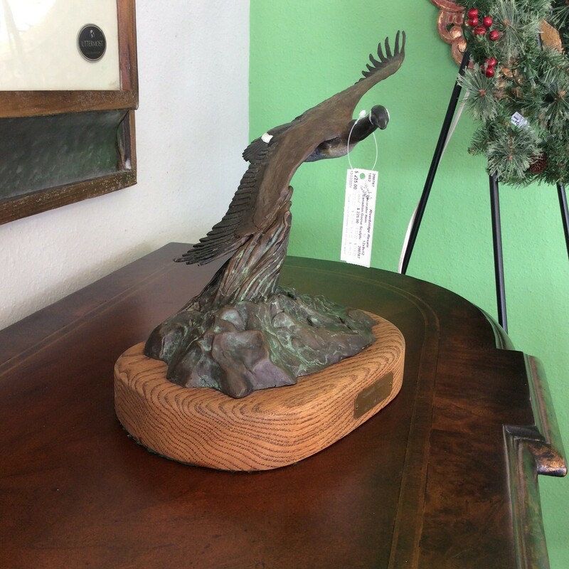 This lovely sculpture of a Canadian goose is by Mike Hollern. Made of bronze. This artist utilizes the unrivaled landscapes of Montana as influences for his bronzes.