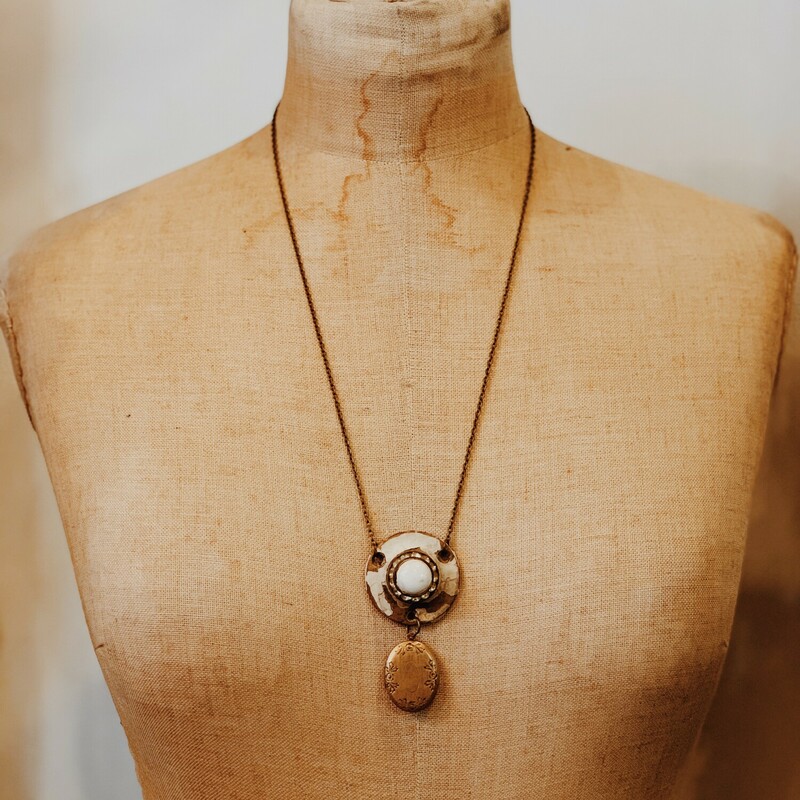 This beautiful, one of a kind necklace is on a 25 inch brass chain. The artist use a keyhole from an antique door as the pendant and hung a locket from it!