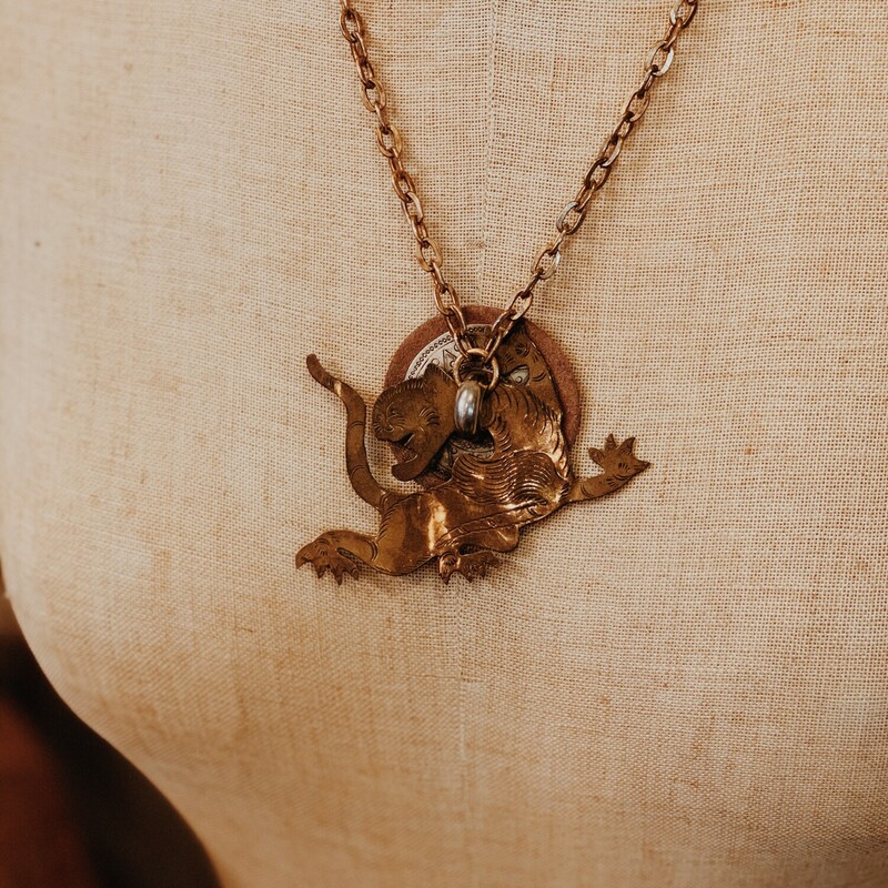 This one of a kind necklace was hand crafted by one of our artists! It features a mythical animal on its pendant made of brass. It is on a 21 inch chain.