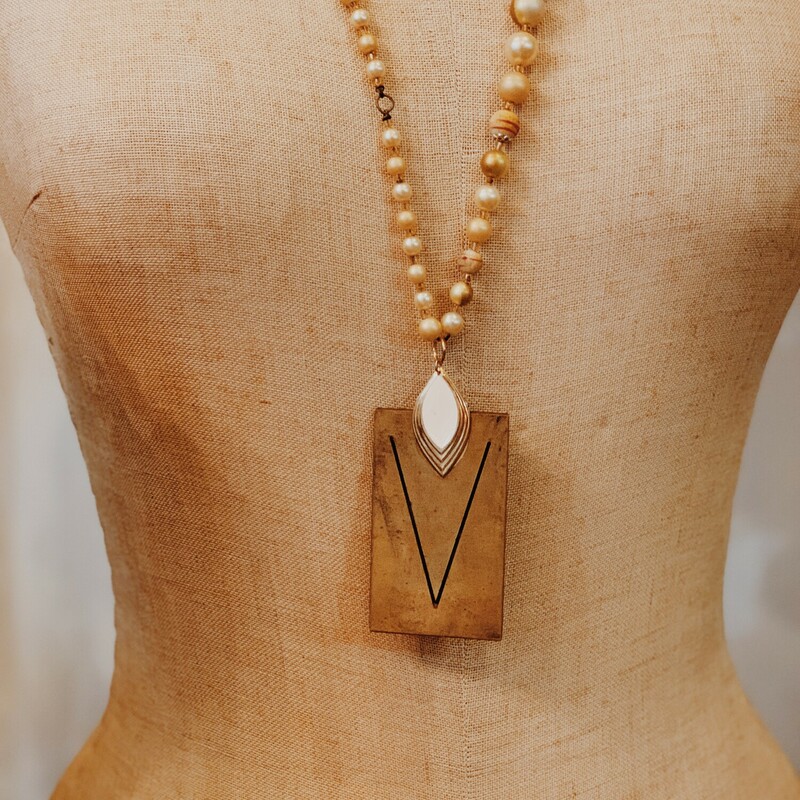 This lovely, handmade necklace is truly one of a kind! It was elegantly crafted and has a V initialed brass plate. It is on a 32 inch beaded chain.