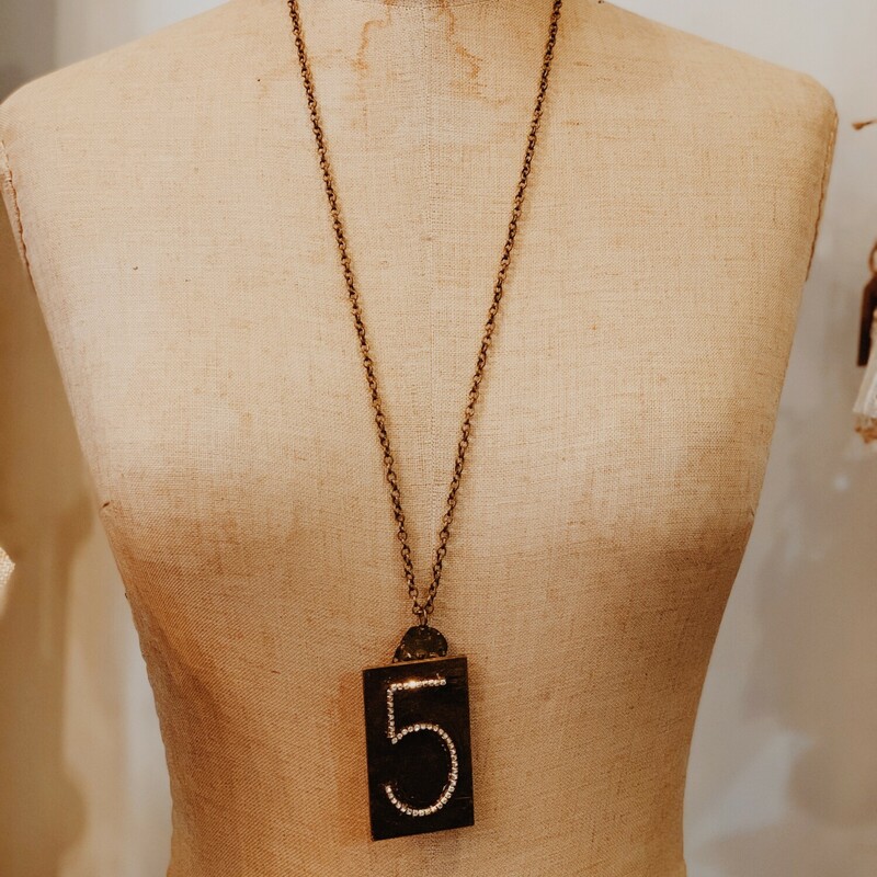 This lovely, handmade necklace is truly one of a kind! It was handcrafted and has a rhinestoned 5 initialed in a  brass plate. It is on a 31 inch chain.