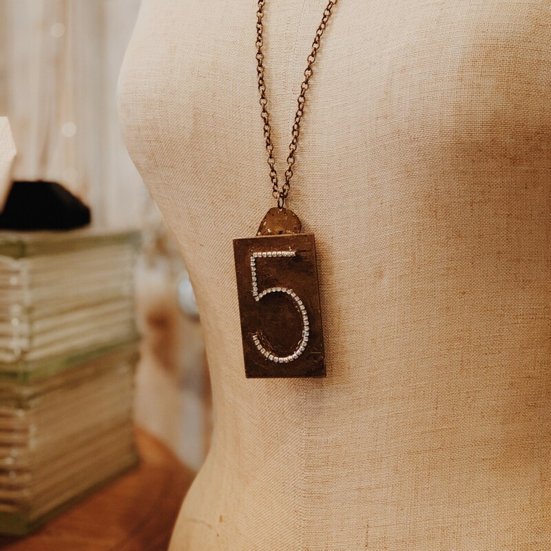 This lovely, handmade necklace is truly one of a kind! It was handcrafted and has a rhinestoned 5 initialed in a  brass plate. It is on a 31 inch chain.