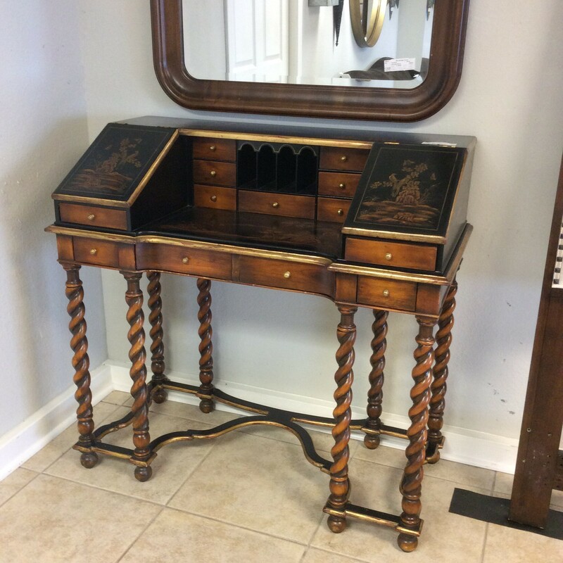 Theodore Alexander Asian style desk. This very impressive desk has thirteen drawers that are all dove tailed.  The desk is black and brown with a gold trim. It also has very pretty barley twisted legs.
An absolutely gorgeous piece!!