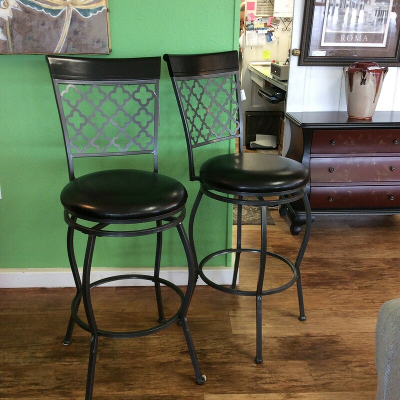 Very sturdy black swivel barstools. They have a pretty filagree design on the back with round faux leather seats.
Measures 29\" tall