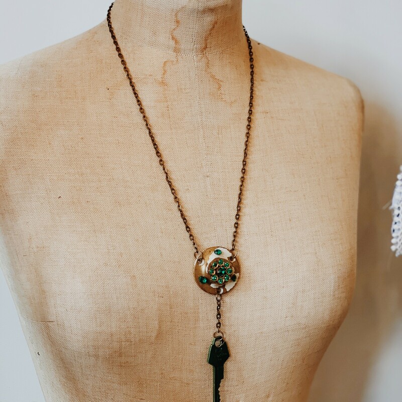 - Handmade necklace
- Vintage door lock and key
- Green accent pieces
- 24.5 inch brass chain