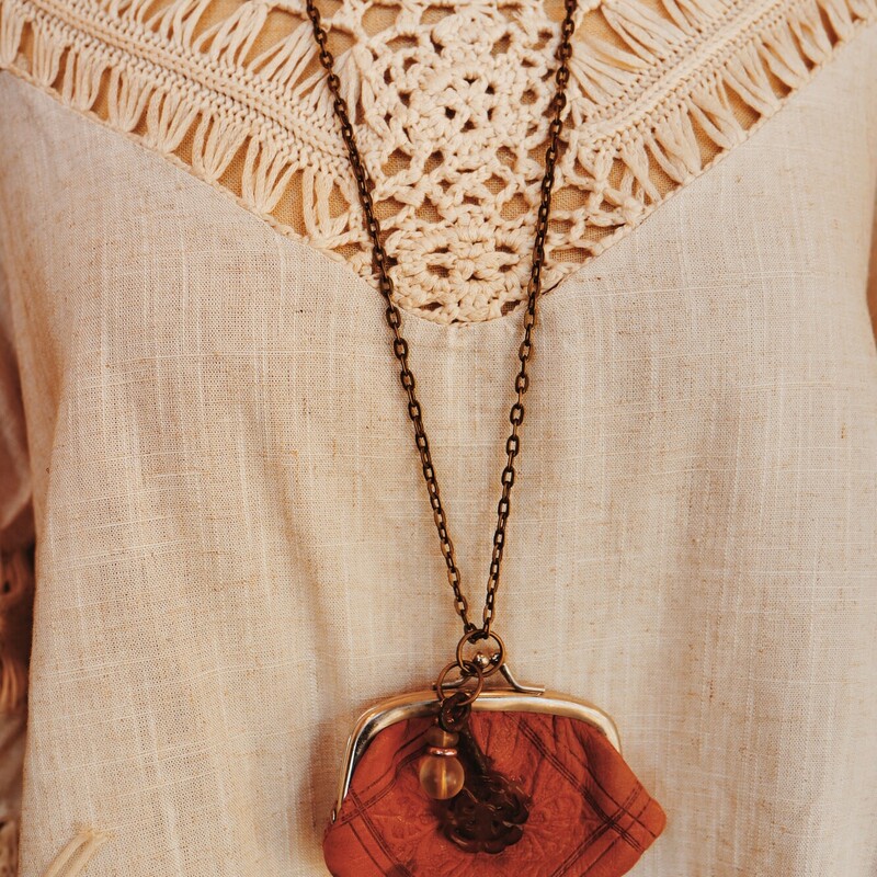 This one of a kind, hand crafted necklace was made from a vintage coin purse and hangs on a 34 inch chain. This is perfect for those who love to stand out!