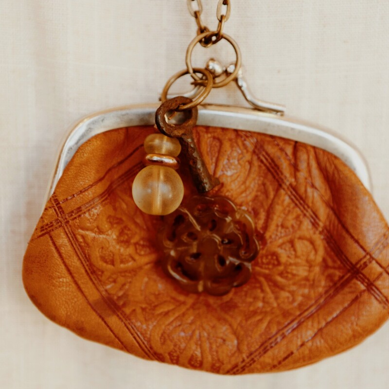 This one of a kind, hand crafted necklace was made from a vintage coin purse and hangs on a 34 inch chain. This is perfect for those who love to stand out!