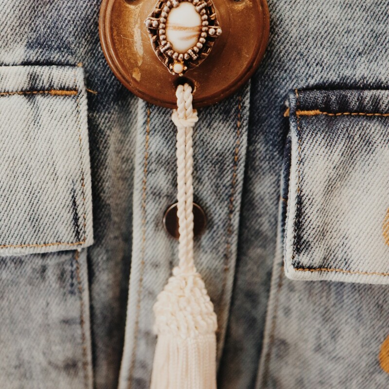 This lovely, hand crafted necklace has a repurposed, antique door lock piece as its pendant with a white tassle hanging from it! It is on a 23 inch chain.