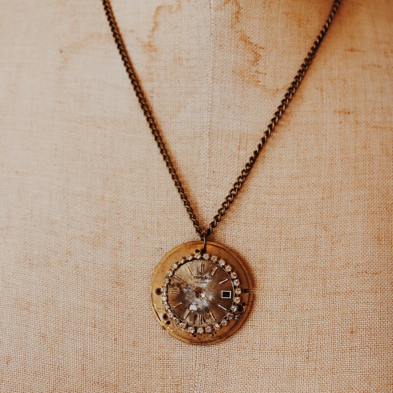 - handmade necklace featuring pocket watch face pendant with surrounding rhinestones
- 10 inch brass chain