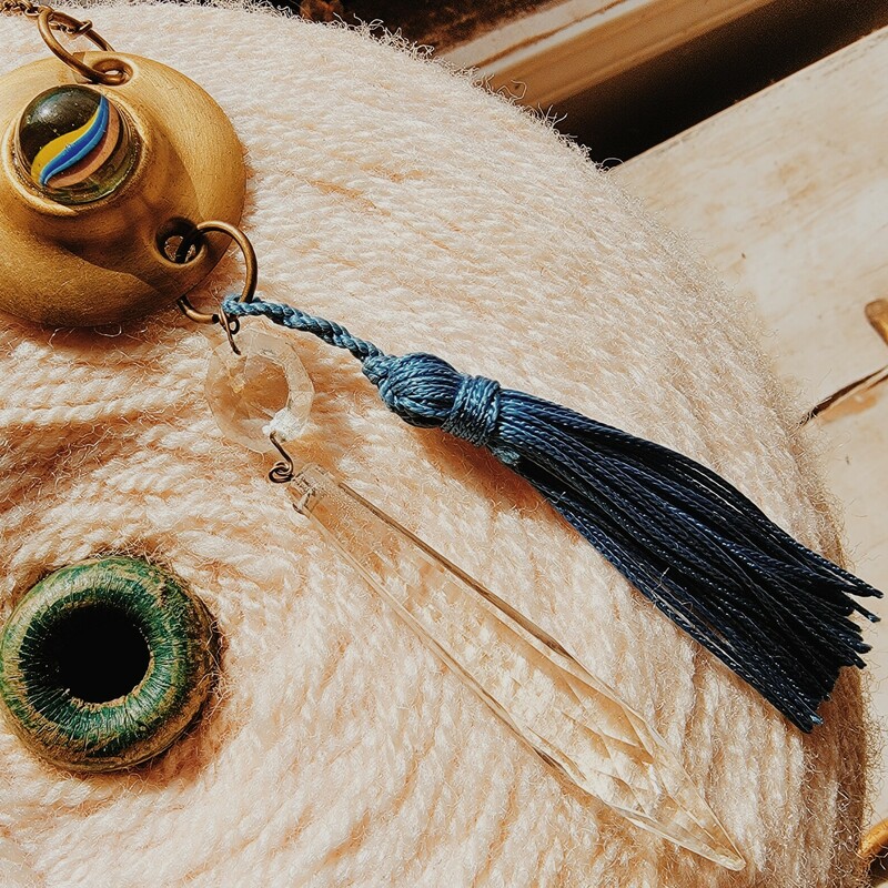 -Hand crafted Necklace
-34 Inch chain
-Marble centerpiece on a gold door piece
-4 Inch blue tassle
4 Inch crystal