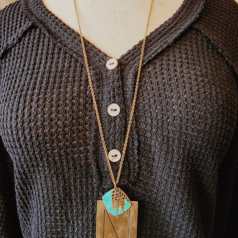 This lovely necklace has an N engraved brass plate and a touch of turquoise! It is on a 32 inch chain.