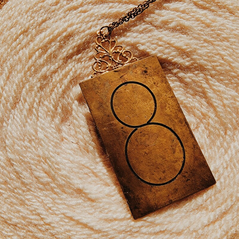 - Hand crafted necklace
- 32 Inch chain
- 8 engraved brass plate