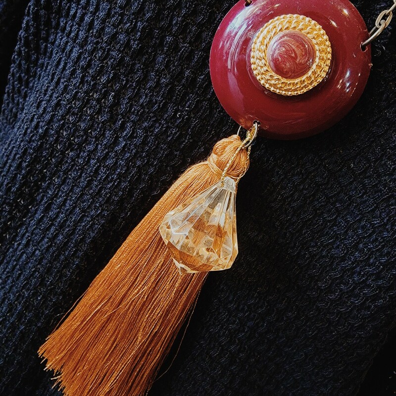 This handmade necklace features a 5 inch tassel hanging fro the pendant! It is on a 30 inch chain.