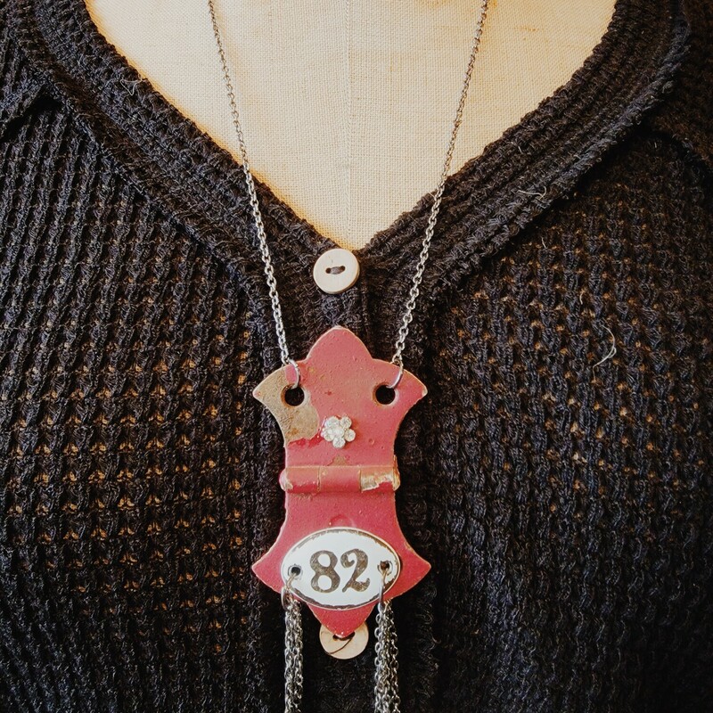 This unique necklace was hand crafted! The artist used a vintage red hinge as a pendant and attached the number 82 with chains hanging from it.
Chain: 24 Inches